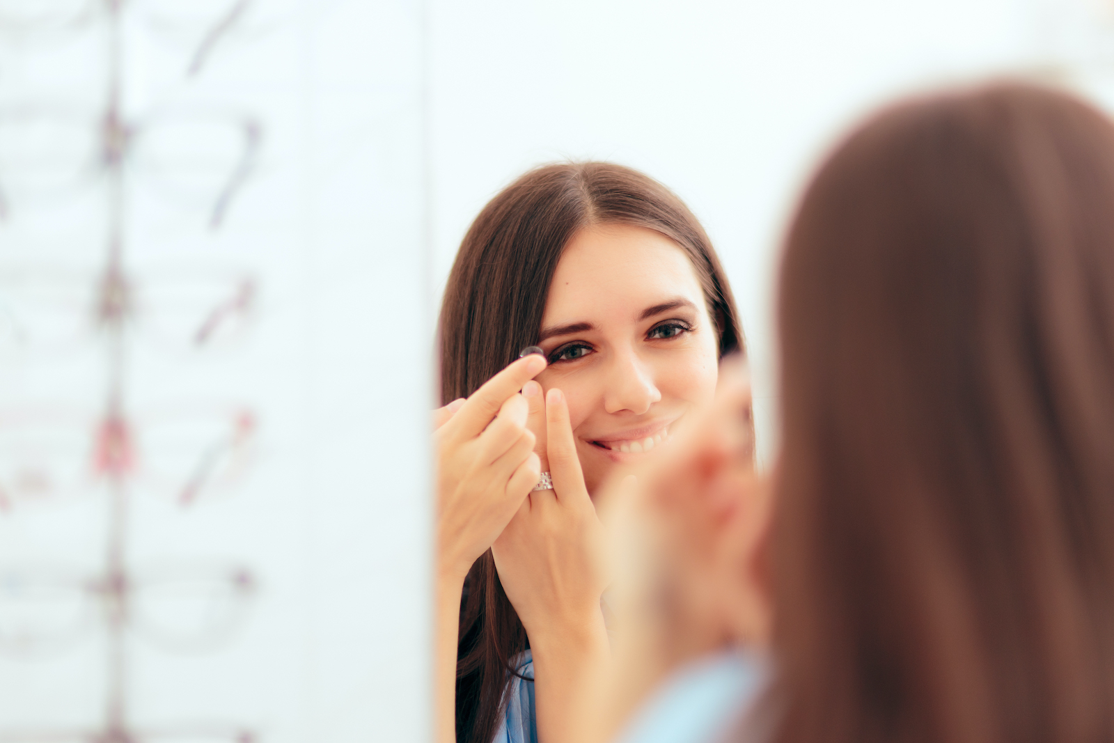 A woman trying on contact lenses at Unity Eye Center